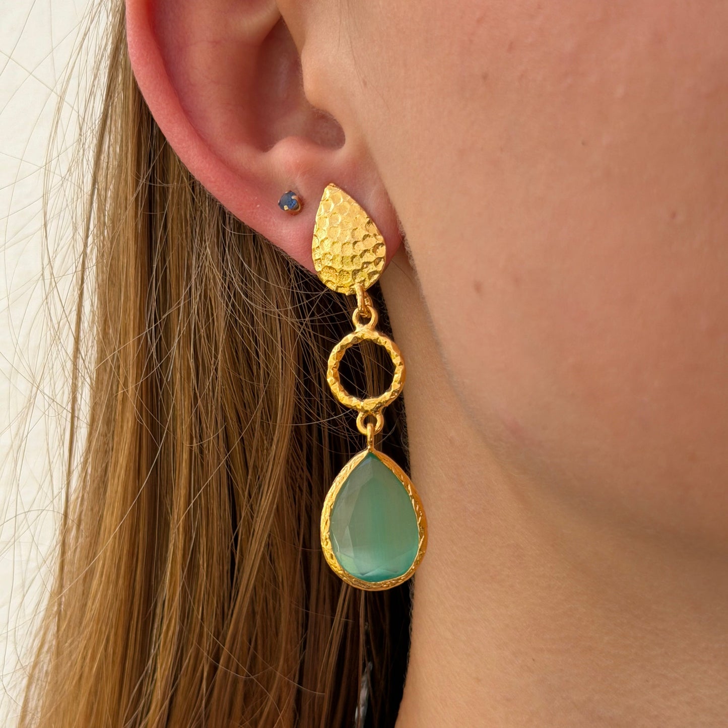 Cats Eye in seafoam color, hammered leaf post connects with a circrle in the middle